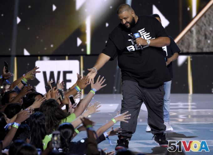 FILE - DJ Khaled greets the audience at WE Day California at the Forum in Inglewood, California.