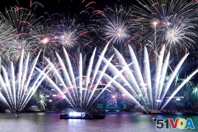 Fireworks explode over Victoria Harbour and Hong Kong Convention and Exhibition Centre during a pyrotechnic show to celebrate the New Year in Hong Kong, China January 1, 2019.