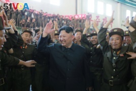 North Korean leader Kim Jong Un reacts with scientists and technicians of the DPRK Academy of Defence Science after the test-launch of the intercontinental ballistic missile Hwasong-14
