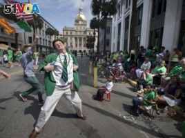 In this March 17, 2015 file photo Lamar Lester III dances while marching with the Doherty Clan during the 191st St. Patrick's Day parade in Savannah, Ga