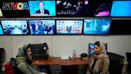 Afghan journalists Banafsha Binesh,and Wheeda Hassan at TOLO TV newsroom in Kabul, Afghanistan, Tuesday, Feb. 8, 2022. 