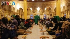 A man prepares food to the faithfuls for the breaking of the Muslim fast during the holy month of Ramadan at La Grande Mosque Moride in Dakar