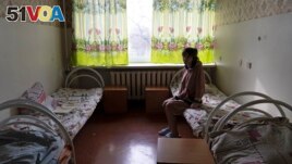 Natalia, 37, a patient, sits in her room at a psychiatric hospital in Kramatorsk, Ukraine, Tuesday March 21, 2023. (AP Photo/Vasilisa Stepanenko)
