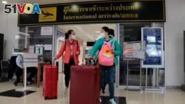 FILE - Chinese tourists arrive at Chiang Mai international airport in Chiang Mai province in northern Thailand, January 23, 2023. (AP Photo/Wichai Thaprieo)