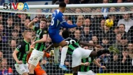 FILE - Chelsea's Levi Colwill, top center, scores a goal during a soccer match between Chelsea and Brighton and Hove Albion, at Stamford Bridge stadium in London on Dec. 3, 2023. (AP Photo/Alastair Grant)