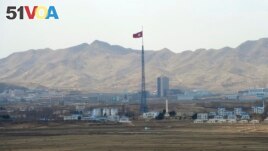 FILE - North Korea's flag flies on a tower high above the village of Ki Jong Dong, as seen from Observation Post Ouellette in the Demilitarized Zone, DMZ, the tense military border between the two Koreas, in Panmunjom, March 25, 2012. (AP Photo/Susan Walsh, File)