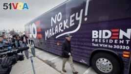 FILE - Democratic presidential candidate and former Vice President Joe Biden boards his No Malarkey bus following a campaign stop in Council Bluffs, Iowa on Nov. 30, 2019. (AP Photo/Nati Harnik)