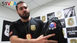 Police detective Arthur Lopes shows a jacket seized from a neo-Nazi group who call themselves Crew 38 in Florianopolis, Santa Catarina state, Brazil April 24, 2023. (REUTERS/Cristiano Estrela)