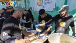 FILE - Members of World Central Kitchen prepare food for Palestinians, in the location given as Gaza, in this picture released on March 21, 2024 and obtained from social media. (Courtesy of @chefjoseandres via X/via REUTERS) 