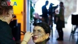 Sparta gets makeup during a photo shoot for the L'Imperfetta model agency in Rome, Tuesday, Feb. 7, 2023.