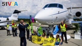 FILE - Environmental activists chained themselves to a plane at the Geneve Aeroport in Geneva, Switzerland, May 23, 2023. (Laurent Gillieron/Keystone via AP, File)