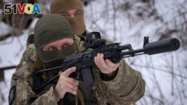 Members of the pro-Ukrainian Russian ethnic Siberian Battalion practice at a military training close to Kyiv, Ukraine, Wednesday, Dec. 13, 2023. (AP Photo/Efrem Lukatsky)