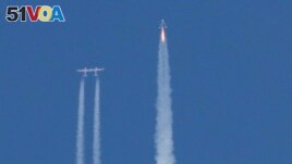 Virgin Galactic's passenger rocket plane VSS Unity, carrying billionaire entrepreneur Richard Branson and his crew, begins its ascent to the edge of space above Spaceport America near Truth or Consequences, New Mexico, U.S., July 11, 2021. REUTERS/Joe Skipper