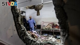 FILE - People inspect the damage in a room following Israeli bombardment at Nasser Hospital in Khan Yunis in the southern Gaza Strip on Dec. 17, 2023. (AFP Photo)