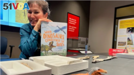 Writer and paleontologist Jingmai O'Connor holds WHEN DINOSAURS CONQUERED THE SKIES , published by The Quarto Group (Photo: Lisa Fielding)