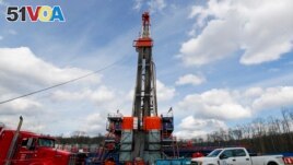 FILE - Work continues at a shale gas well drilling site in St. Mary's, Pa., March 12, 2020.(AP Photo/Keith Srakocic, File)