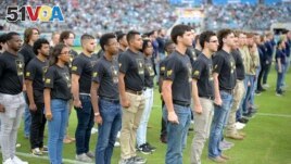 In this file photo, military recruits are sworn in during an NFL football game between the Jacksonville Jaguars and the Las Vegas Raiders, Nov. 6, 2022, in Jacksonville, Fla. (AP Photo/Phelan M. Ebenhack, File)