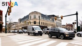 This University of Michigan College photo shows vehicles as they drive through an intersection in Birmingham, Michigan. (Jeremy Little/University of Michigan College of Engineering via AP)