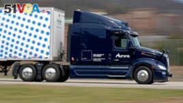 A self-driving tractor-trailer maneuvers around a test track in Pittsburgh, Thursday, March 14, 2024. (AP Photo/Gene J. Puskar)