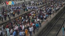 FILE - A busy platform is seen at Chhatrapati Shivaji Maharaj Terminus on World Population Day in Mumbai, India, Tuesday, July 11, 2023. (AP Photo/Rajanish Kakade)