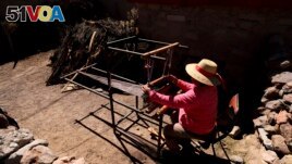 Te<I>&#</I>243;fila Challapa weaves on her loom at home in Cariquima, Chile, on July 31, 2023. Challapa, 59, prays before beginning her work: 