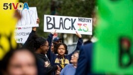 FILE - Hundreds participate in the National Action Network demonstration in response to Gov. Ron DeSantis' rejection of a high school African American history course, Wednesday, Feb. 15, 2023. (Alicia Devine/Tallahassee Democrat via AP, File)