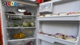 FILE - A Free Food Fridge Albany sidewalk refrigerator is stocked with produce and other food, June 25, 2021, in Albany, N.Y. The nonprofit Free-Go has put refrigerators and food storage centers in Geneva, Switzerland so people can get food. (AP Photo/Hans Pennink)