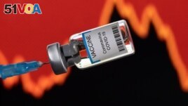 FILE - A vial labelled VACCINE Coronavirus COVID-19 is seen in front of a stock graph in this illustration taken on January 17, 2022. (REUTERS/Dado Ruvic/Illustration)