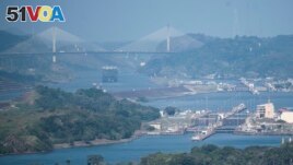 A cargo ship waits near the Centennial Bridge for transit through the Panama Canal locks, in Panama City, Wednesday, Jan. 17, 2024. (AP Photo/Agustin Herrera)
