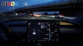 FILE - A Tesla Model 3 vehicle drives on autopilot along the 405 highway in Westminster, California, U.S., March 16, 2022. (REUTERS/Mike Blake)