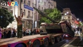 Members of the Wagner Group military company load their tank onto a truck on a street in Rostov-on-Don, Russia, Saturday, June 24, 2023, prior to leaving an area at the headquarters of the Southern Military District. (AP Photo, File)