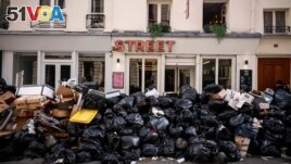 Uncollected garbage is piled up on a street in Paris, March 15, 2023, during an ongoing strike by sanitation workers. (AP Photo/Thomas Padilla, File)