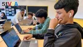 Bryan Martinez, a senior at Capital City Public Charter School in Washington, works on a computer during his Advanced Algebra with Financial Applications class on Sept. 12, 2023. (Jackie Valley/The Christian Science Monitor via AP) /