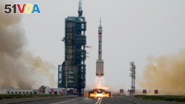A Long March rocket carrying a crew of Chinese astronauts in a Shenzhou-16 spaceship lifts off at the Jiuquan Satellite Launch Center in northwestern China, Tuesday, May 30, 2023. (AP Photo/Mark Schiefelbein)
