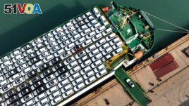 This photo taken on December 5, 2023 shows cars being loaded onto a ship for export at the port in Lianyungang, in China's eastern Jiangsu province. (Photo by AFP) 