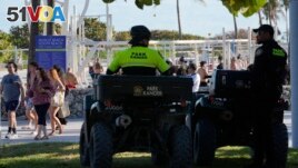 Miami Beach park rangers watch over crowds Tuesday, Feb. 27, 2024, in Miami Beach, Fla. (AP Photo/Marta Lavandier)