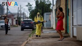 Health workers spray insecticide to kill mosquitos. This is to help slow a dengue outbreak in Brasilia, Brazil, on January 24, 2024. (REUTERS/Adriano Machado)