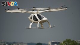 The Volocopter 2X, an electric vertical takeoff and landing multicopter, performs a demonstration flight during the Paris Air Show in Le Bourget, north of Paris, France, Monday, June 19, 2023. (AP Photo/Lewis Joly)