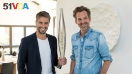 Paris 2024 chief Tony Estanguet and designer Mathieu Lehanneur present the torch that will be carried by 11,000 people in the 2024 Olympic Games. The photo was taken on July 25, 2023. (Courtesy Photo)