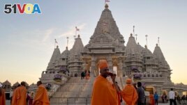 Monks walk in front of the BAPS Swaminarayan Akshardham, the largest Hindu temple outside India in the modern era, on Oct. 4, 2023, in Robbinsville, N.J. (AP Photo/Luis Andres Henao)