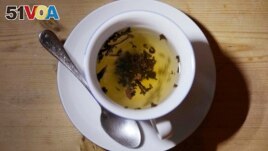 FILE - A cup of black tea with a spoon and tea leaves in London, on Aug. 29, 2022. An American scientist has started a tempest in a teapot by offering Britain advice on its favorite drink: tea. (AP Photo/Alastair Grant, File)