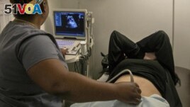 FILE - A technician performs an ultrasound on a pregnant patient in Shreveport, La., Wednesday, July 6, 2022. (AP Photo/Ted Jackson, File)