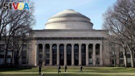 FILE - Students walk past the Great Dome atop Building 10 on the Massachusetts Institute of Technology campus, April 3, 2017, in Cambridge, Mass. (AP Photo/Charles Krupa, File)