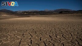 Part of the Vinuela reservoir is seen dry due to lack of rain in La Vinuela, southern Spain, Feb. 22, 2022. Declining agricultural yields and reduced water resources are key risks as global temperatures continue to rise. (AP Photo/Carlos Gil)