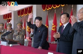 In an image made from video, North Korean leader Kim Jong Un, center, and Liu Yunshan, China's Communist Party's No. 5 leader, second right, waves during a ceremony to mark the 70th anniversary of the country's ruling party, in Pyongyang, Oct. 10, 2015. (KRT via AP Video) 