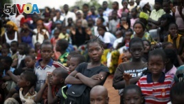 Children watch pro-government supporters gathering for an election rally in Bamako, Mali.