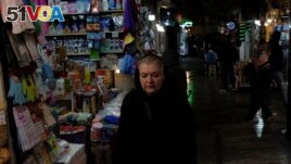 A woman walks through Tajrish bazaar in northern Tehran, Iran, Monday, Dec. 5, 2022. Confusion over the status of Iran's religious police grew as state media cast doubt on reports the force had been shut down. (AP Photo/Vahid Salemi)