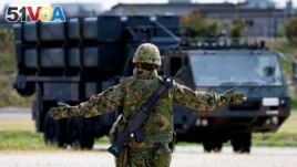 FILE - A member of the Japan Ground Self-Defense Force (JGSDF) conducts a military drill with an anti-ship missiles unit, at JGSDF Miyako camp on Miyako Island, Okinawa prefecture, Japan, Apr. 21, 2022. 