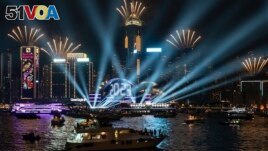 Fireworks are seen over Victoria Harbour at midnight on New Years Sunday Jan. 1, 2023 in Hong Kong. (AP Photo/Anthony Kwan)