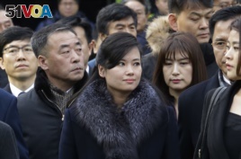 North Korean Hyon Song Wol, center, head of a North Korean art troupe, watches while South Korean protesters stage a rally against her visit in front of Seoul Railway Station in Seoul, South Korea, Monday, Jan. 22, 2018.